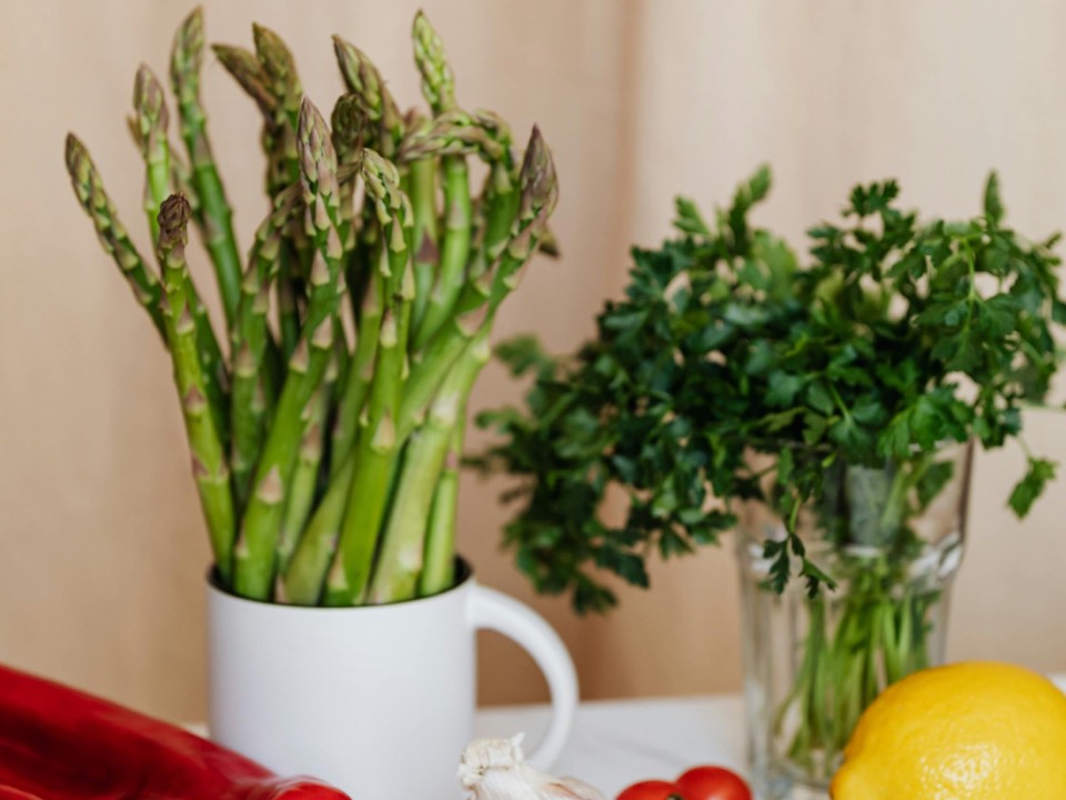 Fresh vegetables and herbs on a kitchen counter for dairy-free low-FODMAP meal planning